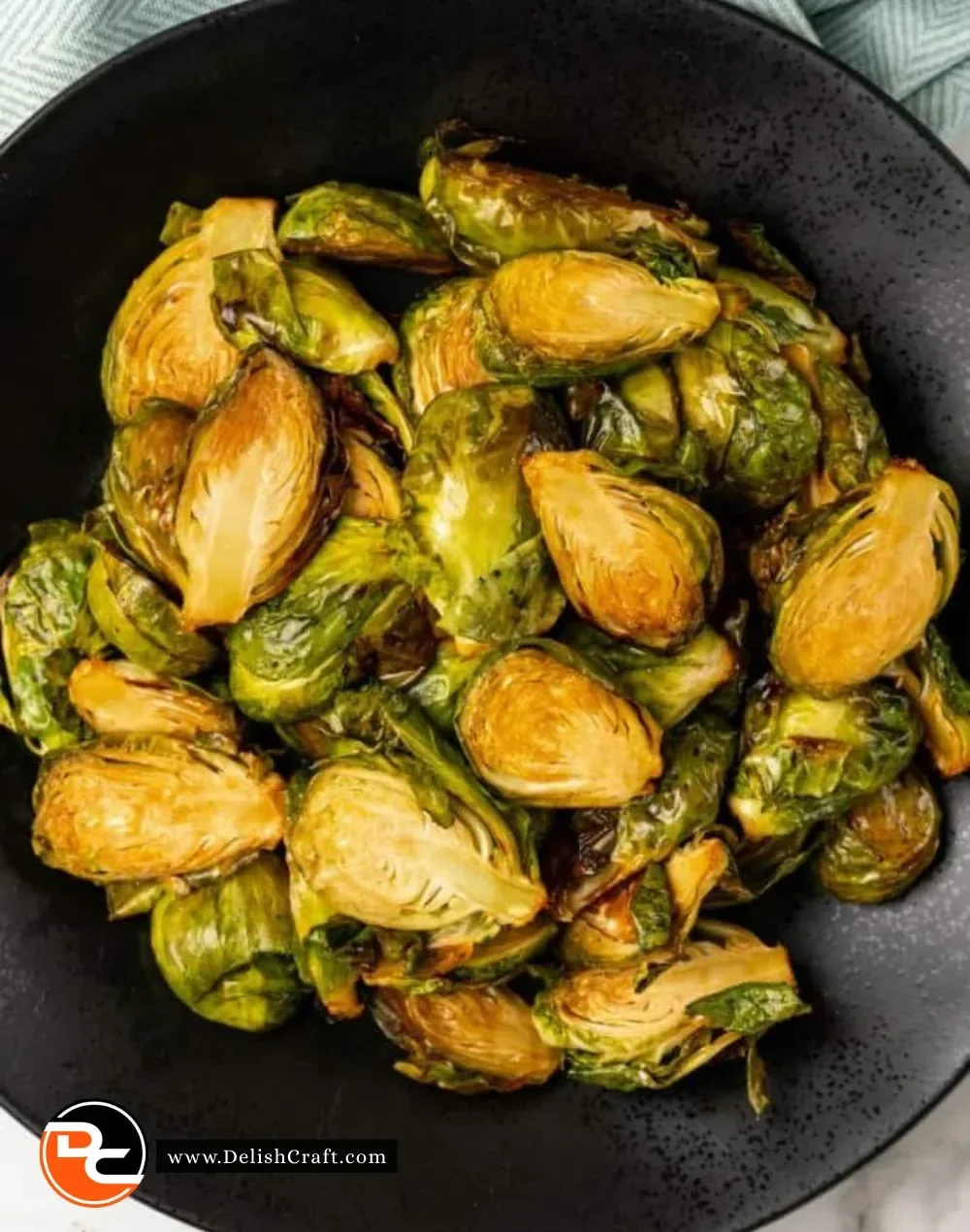 Ninja Foodi Brussels Sprouts cooked to perfection in a vibrant green dish.