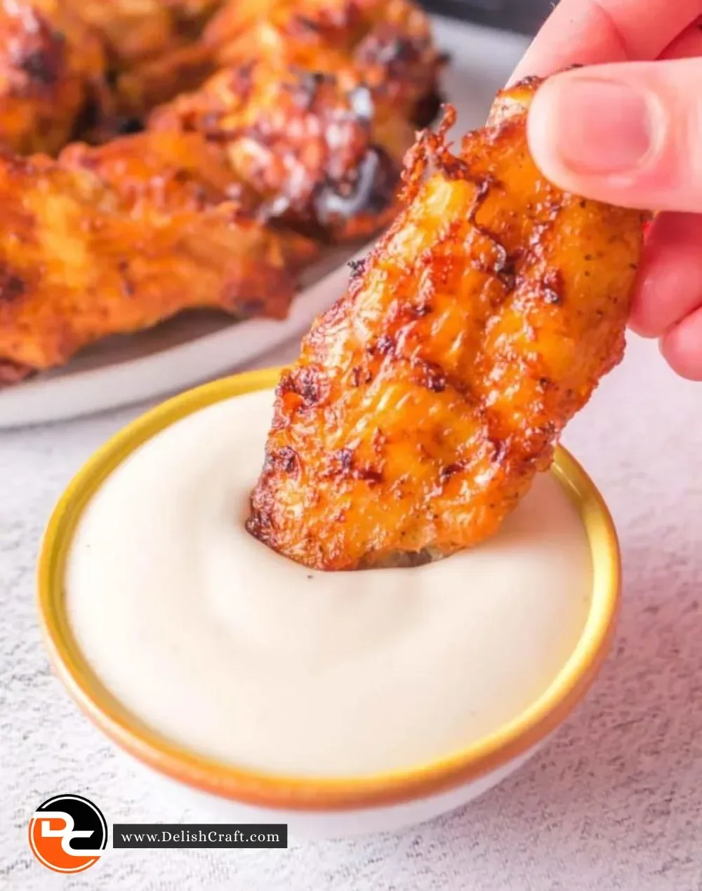 Crispy Ninja Foodi chicken wings served on a platter with dipping sauce