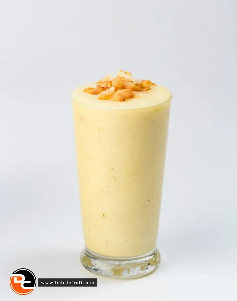 Tropical Pineapple Coconut Smoothie in a glass with garnish