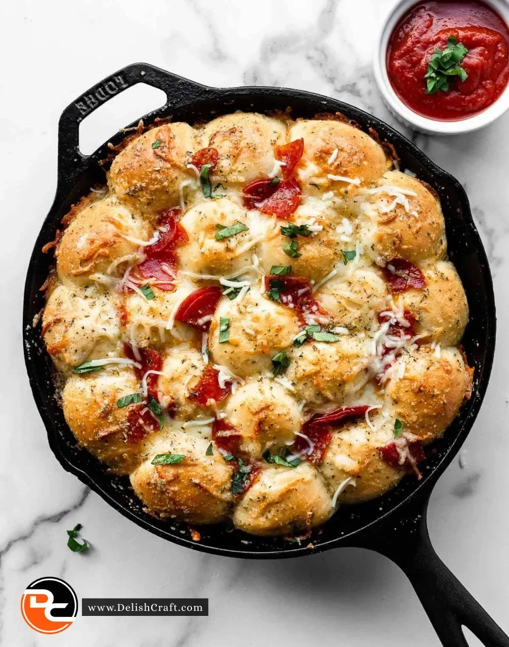 Cheesy Pizza Pull Apart Rolls with marinara dipping sauce on a wooden table.