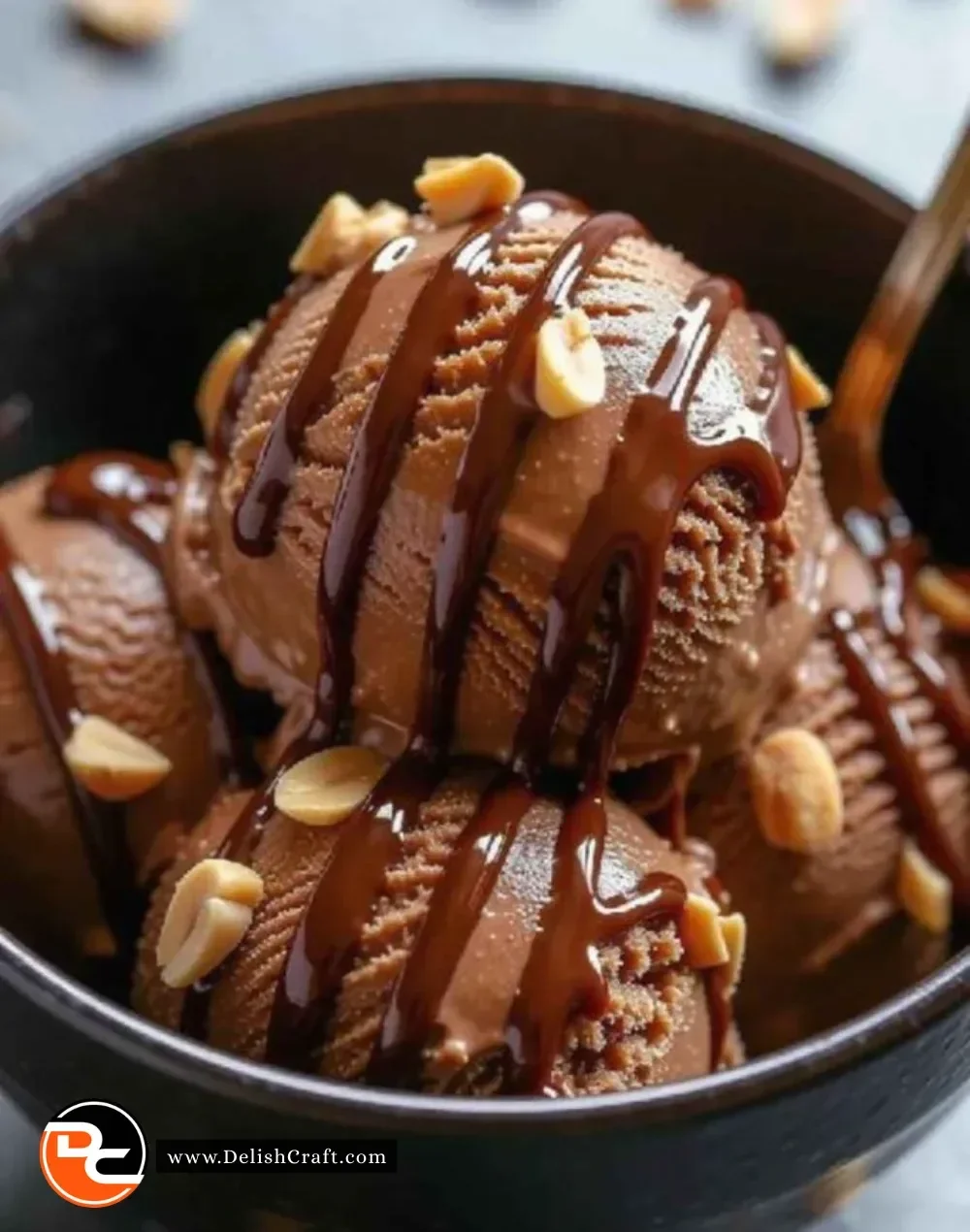 Protein-packed chocolate peanut butter ice cream in a bowl with a scoop on top