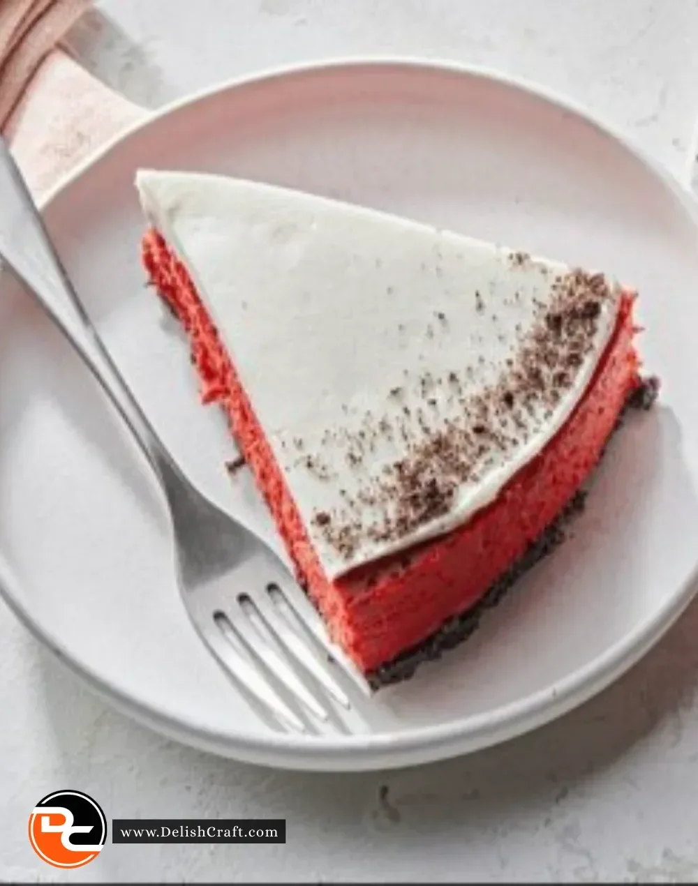 Red Velvet Christmas Cheesecake topped with cream and festive decor
