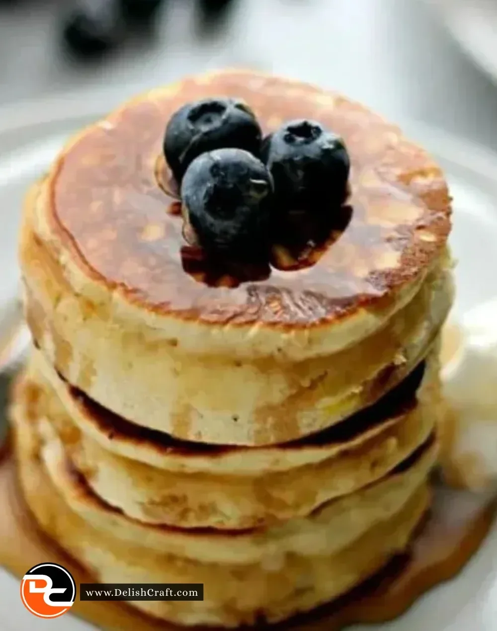Delicious Scottish pancakes served with fresh fruits and syrup.