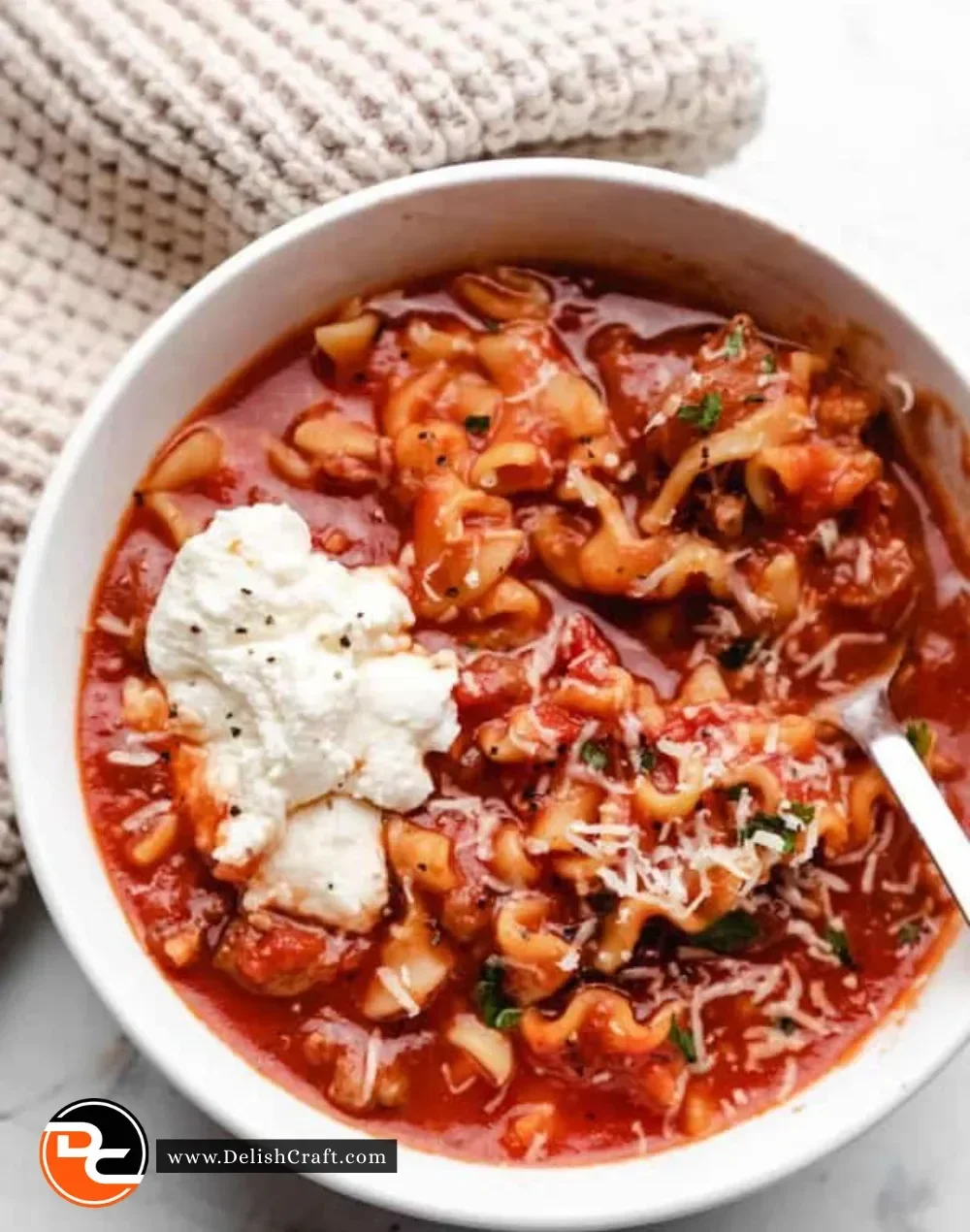 Delicious slow cooker lasagna soup topped with cheese and herbs
