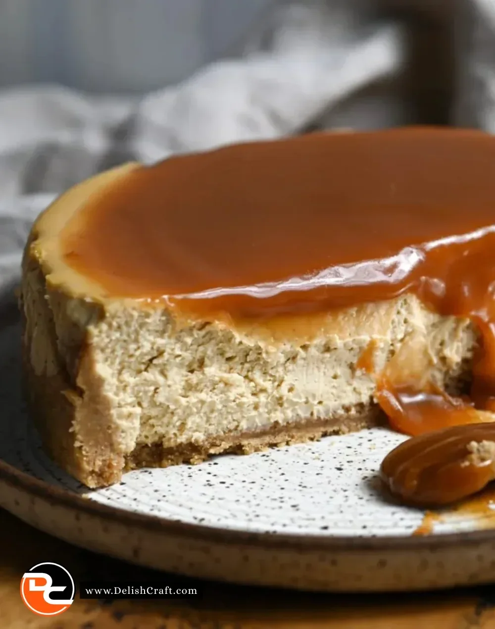 Delicious spiced apple cider cheesecake topped with whipped cream and cinnamon.