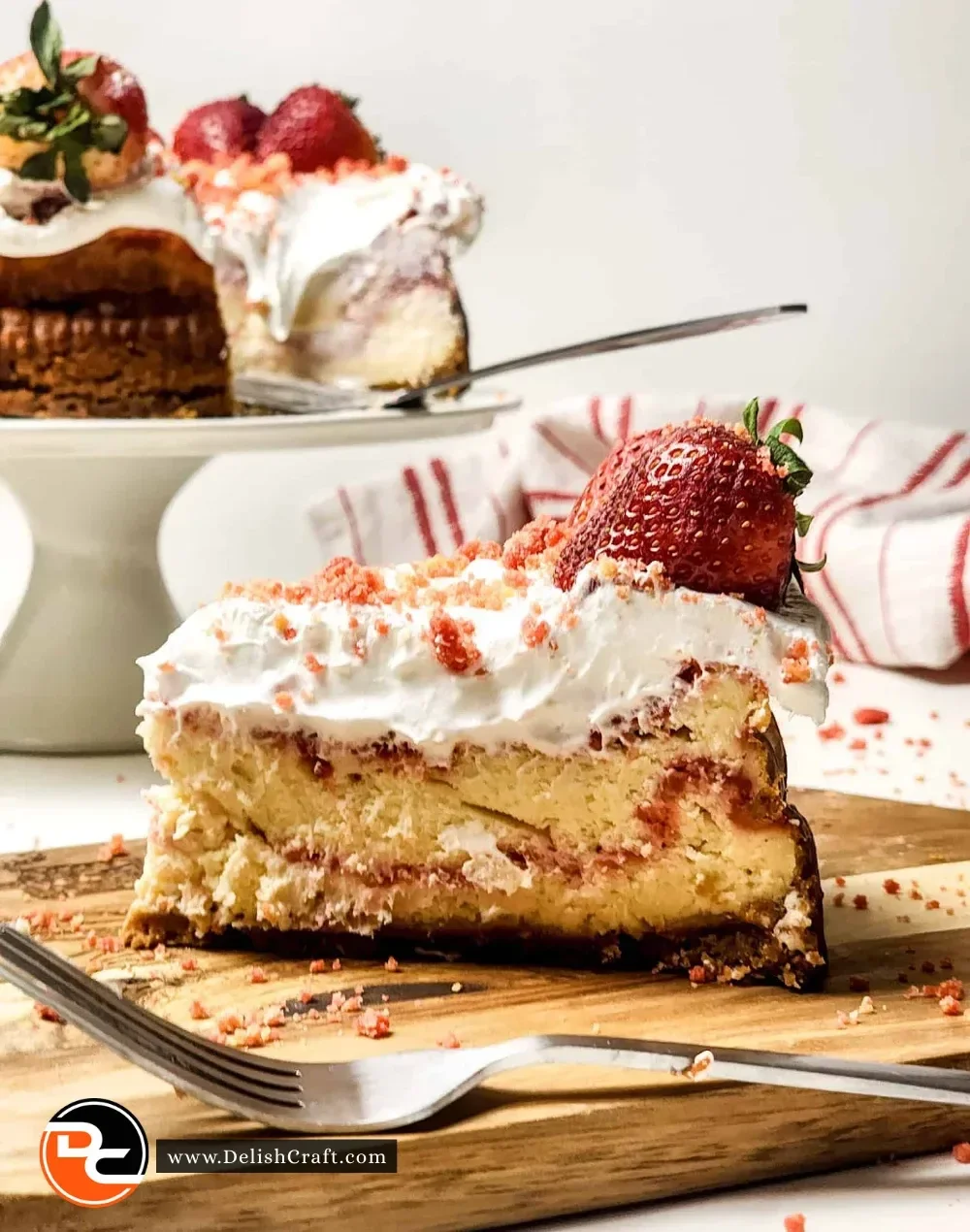Slice of Strawberry Crunch Cheesecake topped with fresh strawberries and crunchy bits