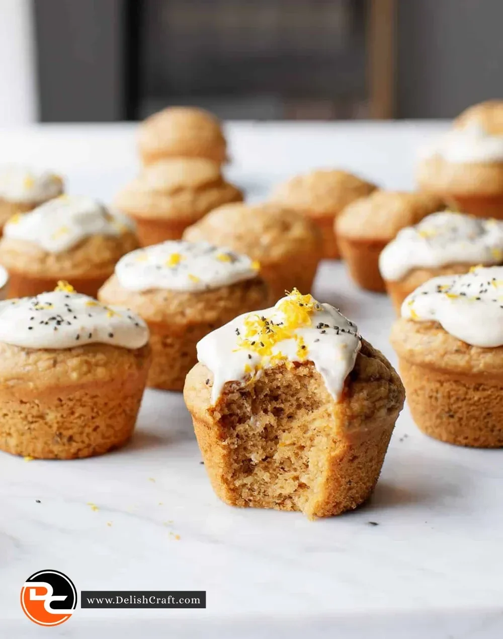 Freshly baked vegan lemon muffins with lemon slices on top