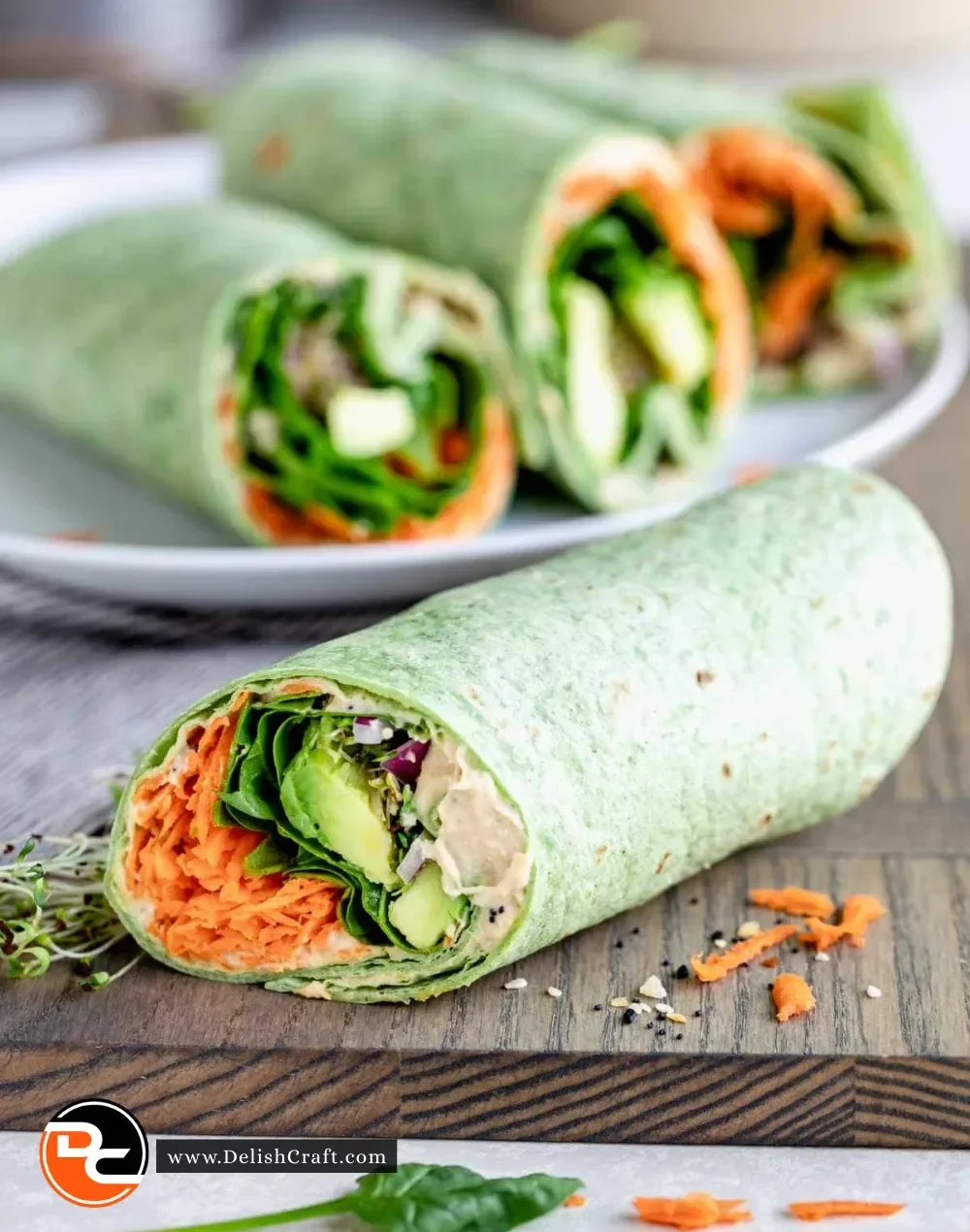 Veggie spinach wraps filled with hummus and fresh vegetables
