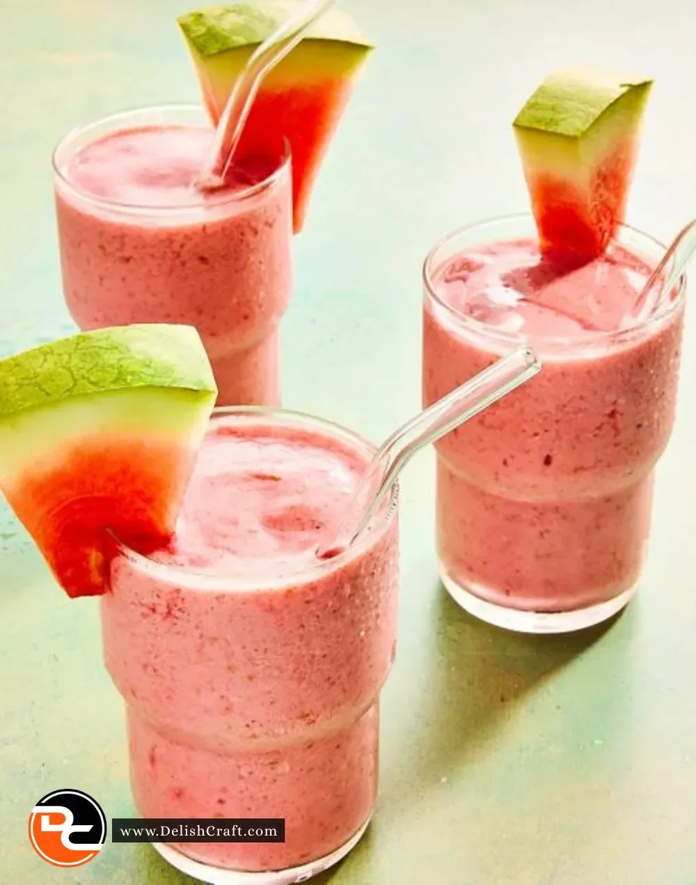 Delicious watermelon smoothie in a glass garnished with mint leaves.
