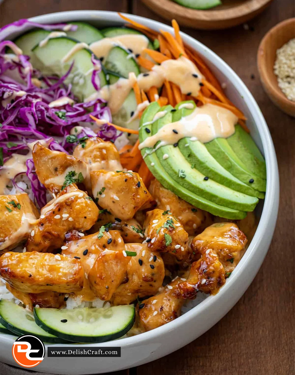 Delicious Bang Bang Chicken Bowl garnished with fresh vegetables and spices