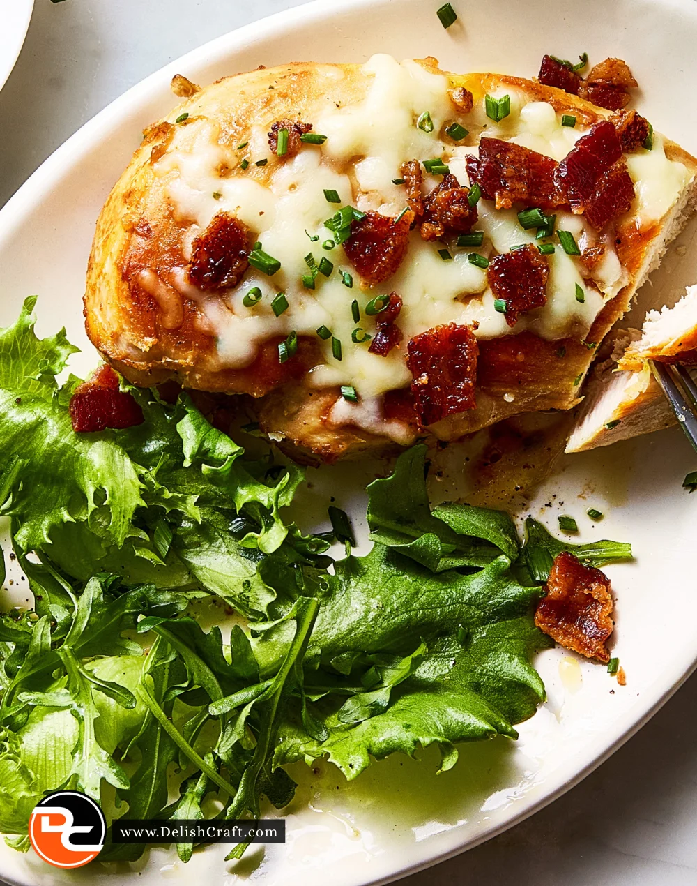 Creamy Cheesy Bacon Ranch Chicken casserole topped with crispy bacon