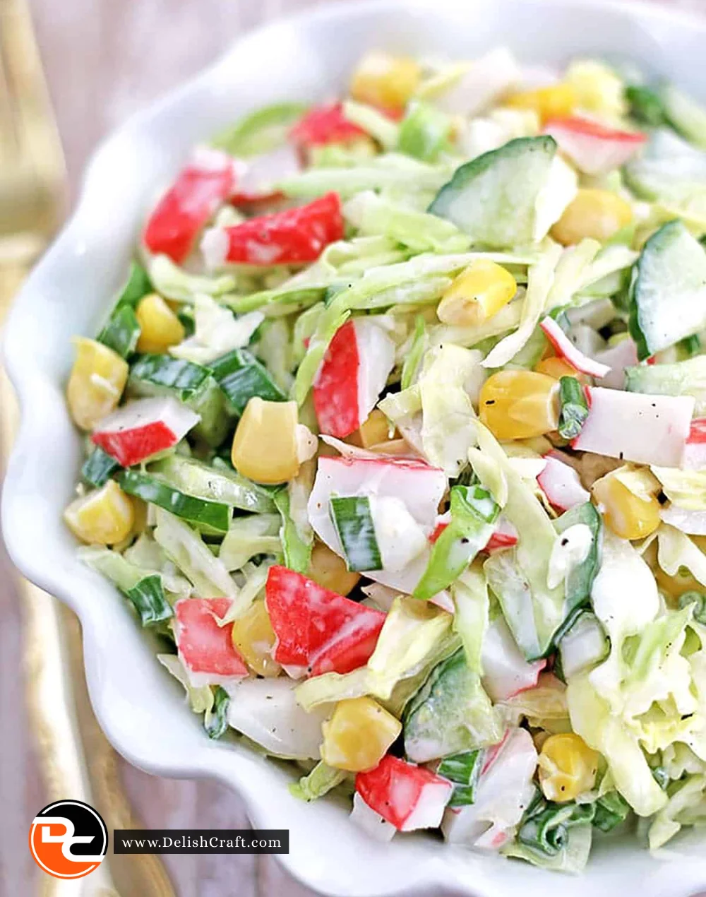 Delicious crab salad with fresh vegetables and herbs served in a bowl
