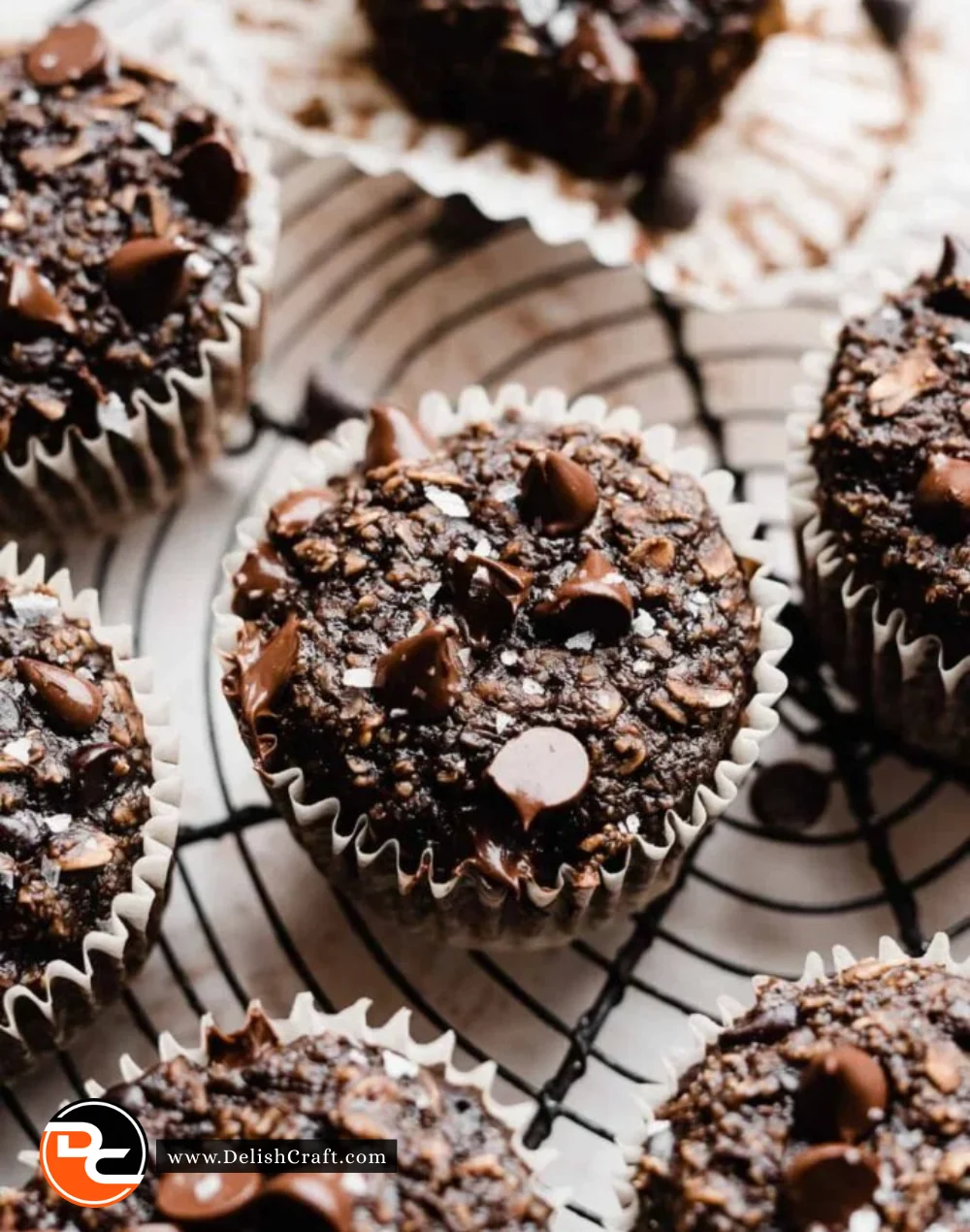 Healthy chocolate muffins fresh out of the oven, topped with chocolate chips.