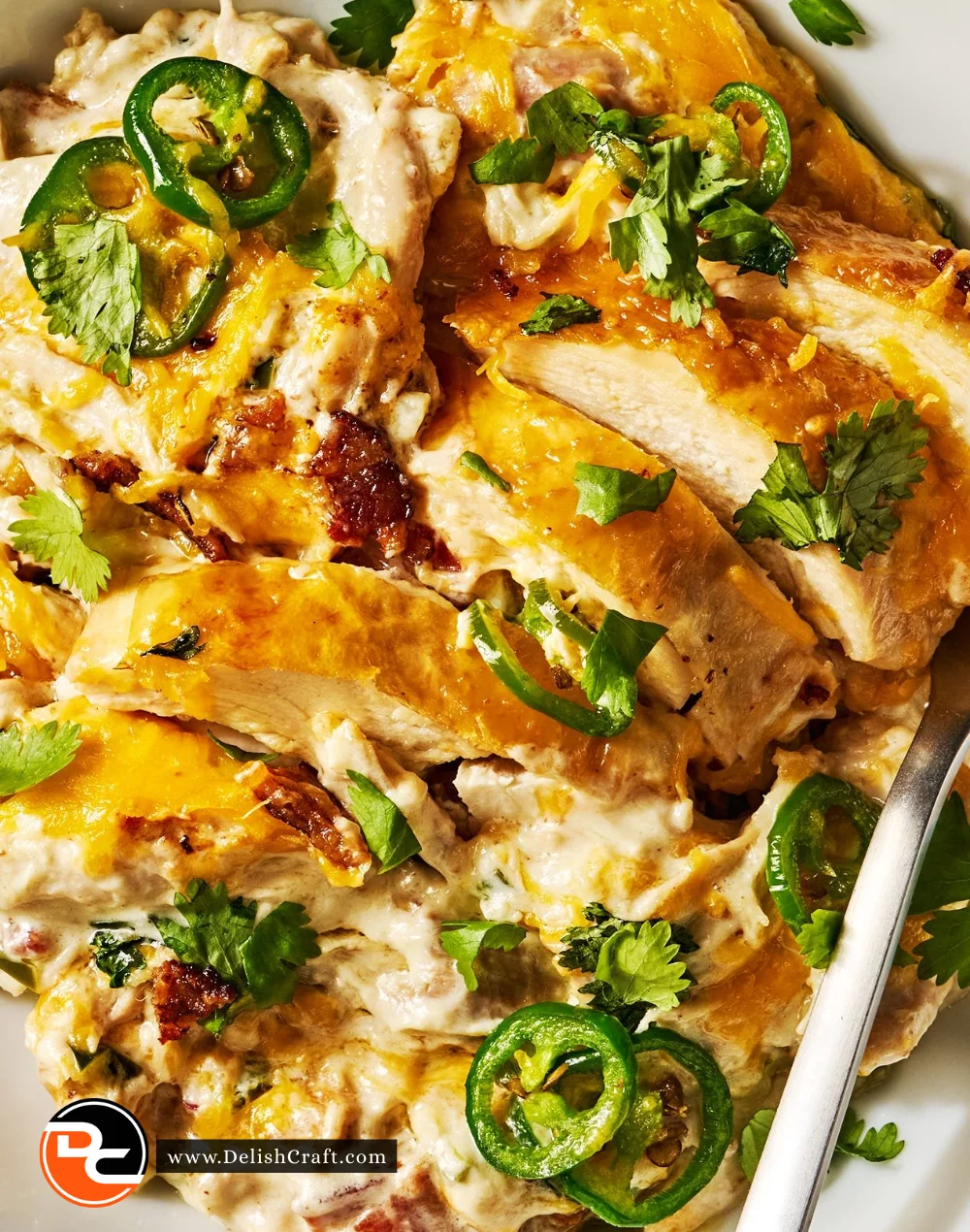 Delicious Jalapeño Popper Chicken Skillet topped with cheese and jalapeños
