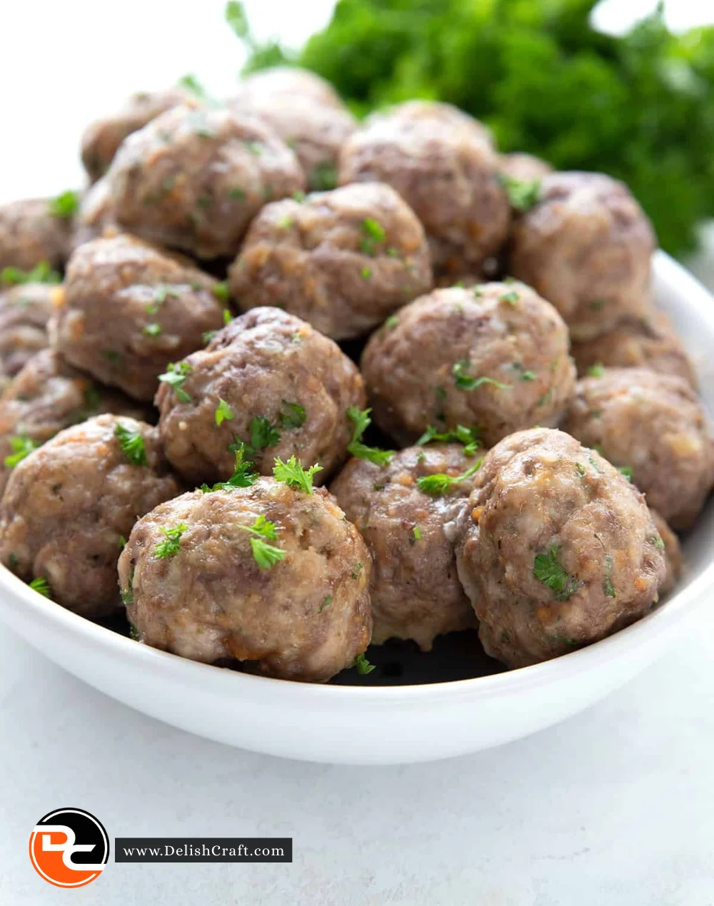 Plate of flavorful Keto Meatballs garnished with herbs.