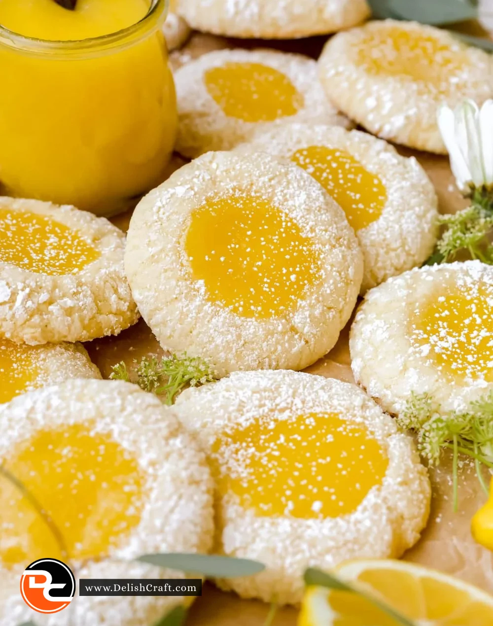 Plate of freshly baked lemon cookies with a yellow lemon zest garnish.
