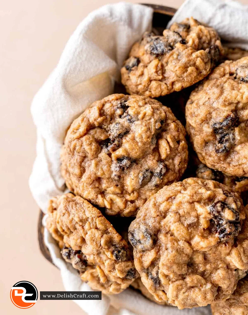 Freshly baked oatmeal raisin cookies on a cooling rack.