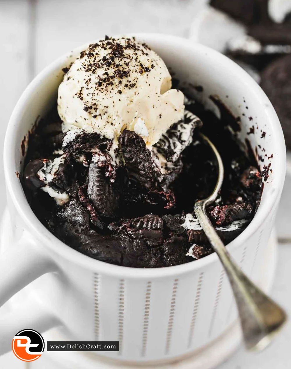 Delicious Oreo Mug Cake topped with crushed Oreos in a white mug