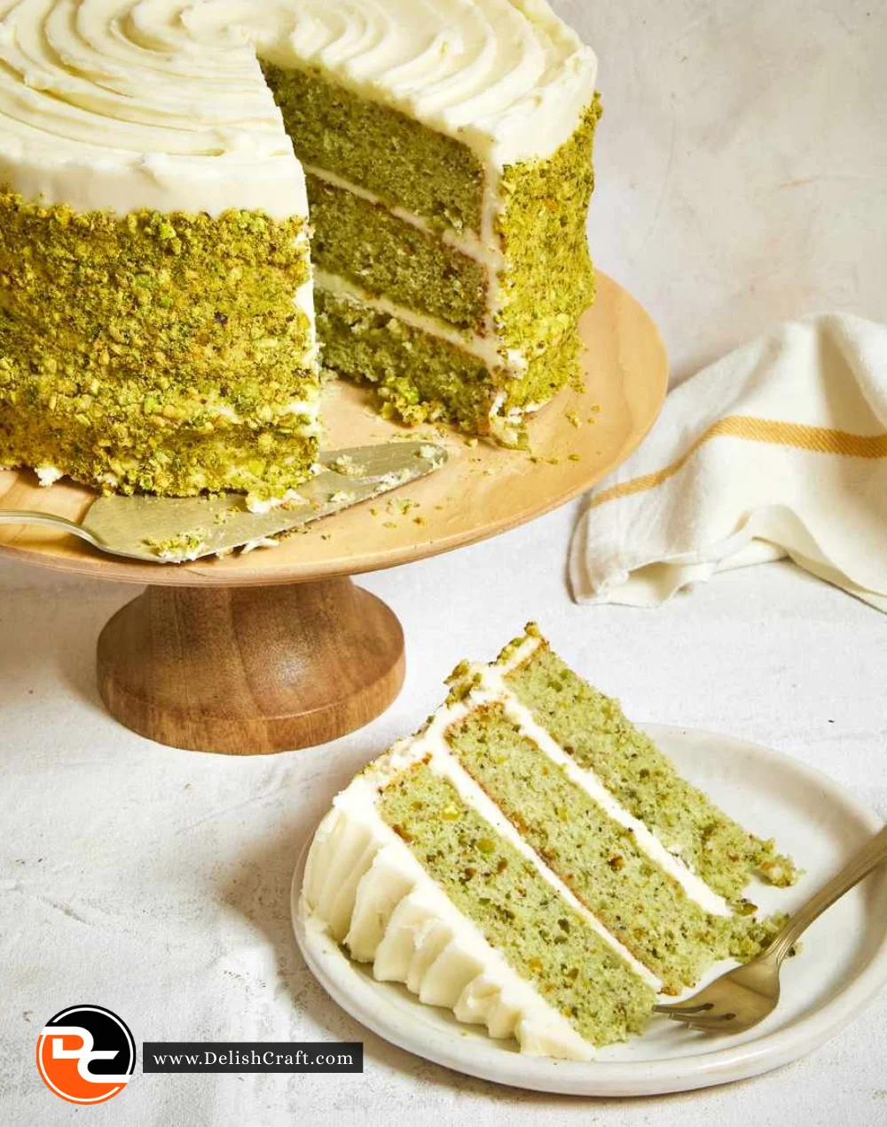 Delicious homemade pistachio cake topped with nuts and frosting