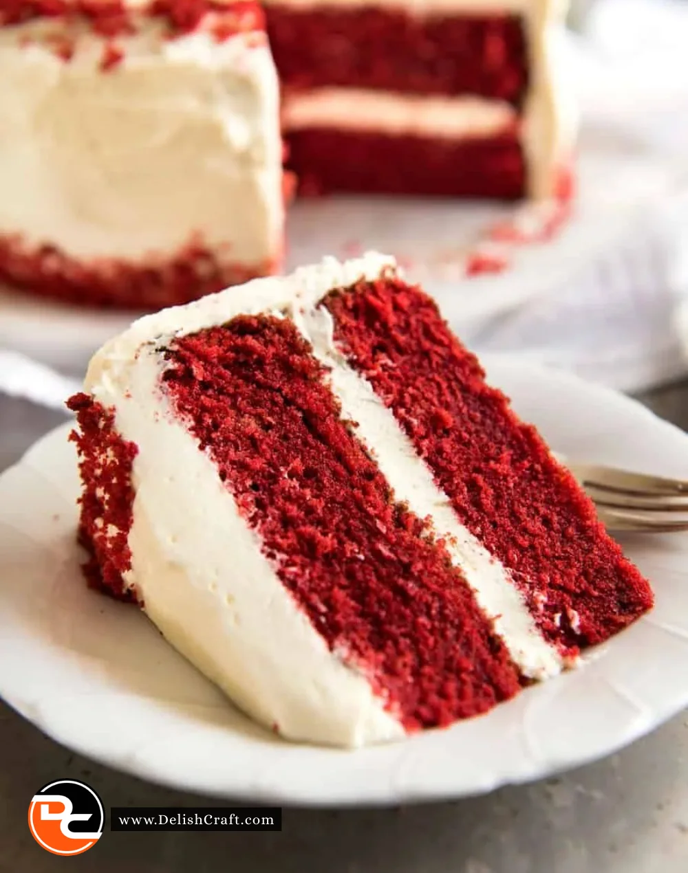 Delicious slice of red velvet cake topped with cream cheese frosting