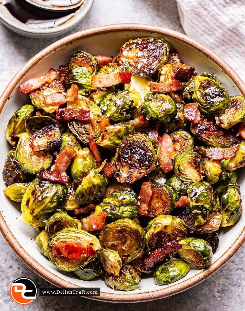 Roasted Brussels sprouts with bacon on a plate garnished with herbs