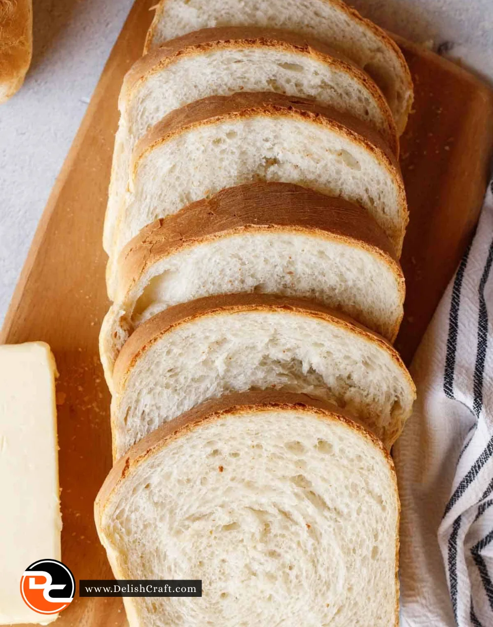 Freshly baked sandwich bread on a rustic wooden table.