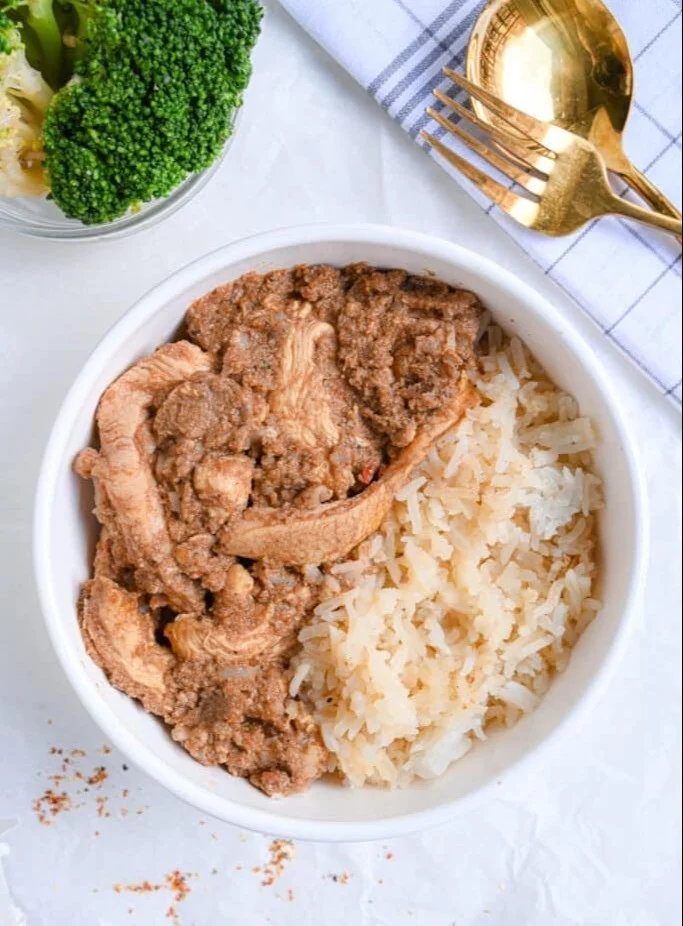 Delicious high protein chicken curry served with rice and garnished with cilantro