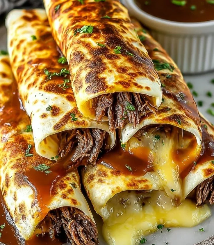 French Dip Tortilla Roll Ups served with au jus dipping sauce