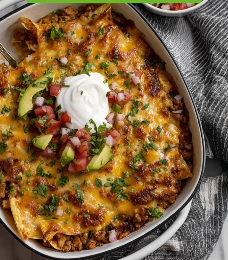 Delicious ground chicken taco casserole topped with cheese and toppings