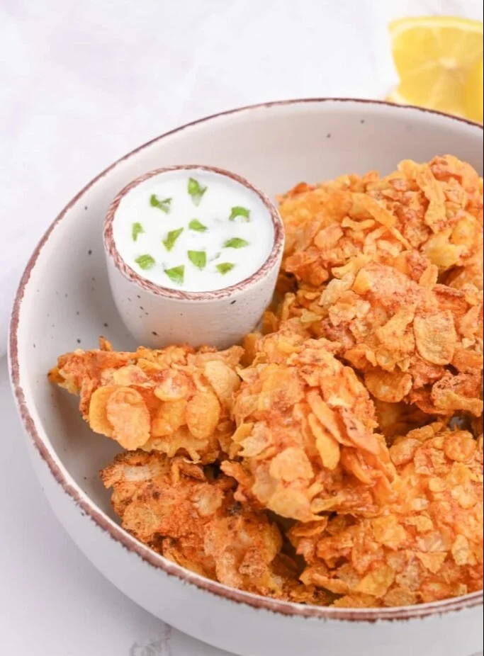 Healthy cornflake chicken nuggets baked and served with dipping sauce