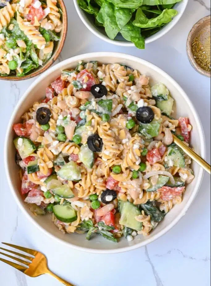 High protein pasta salad with vegetables and dressing in a bowl