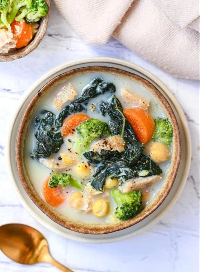 A bowl of high protein soup filled with vegetables and legumes for a nutritious meal.