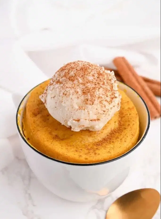 Protein pumpkin mug cake served in a festive mug
