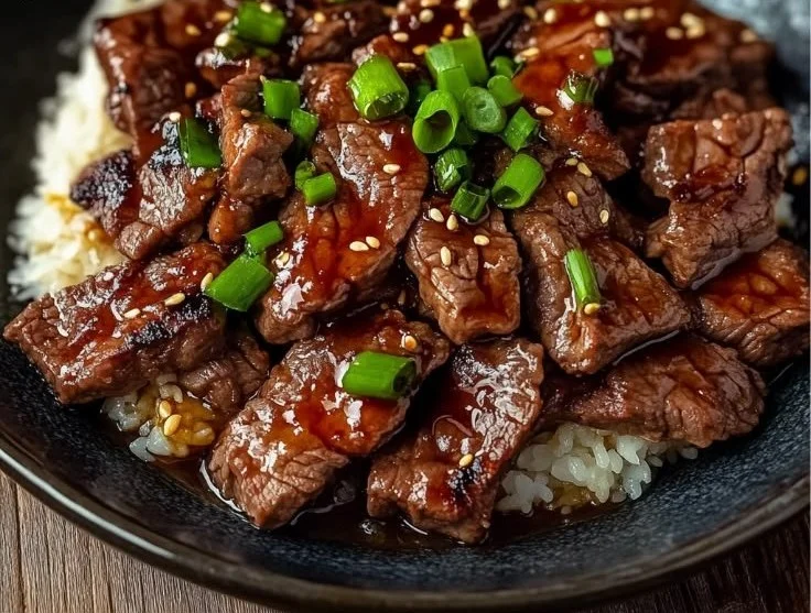 Sizzling beef yakiniku served with dipping sauces and grilled vegetables