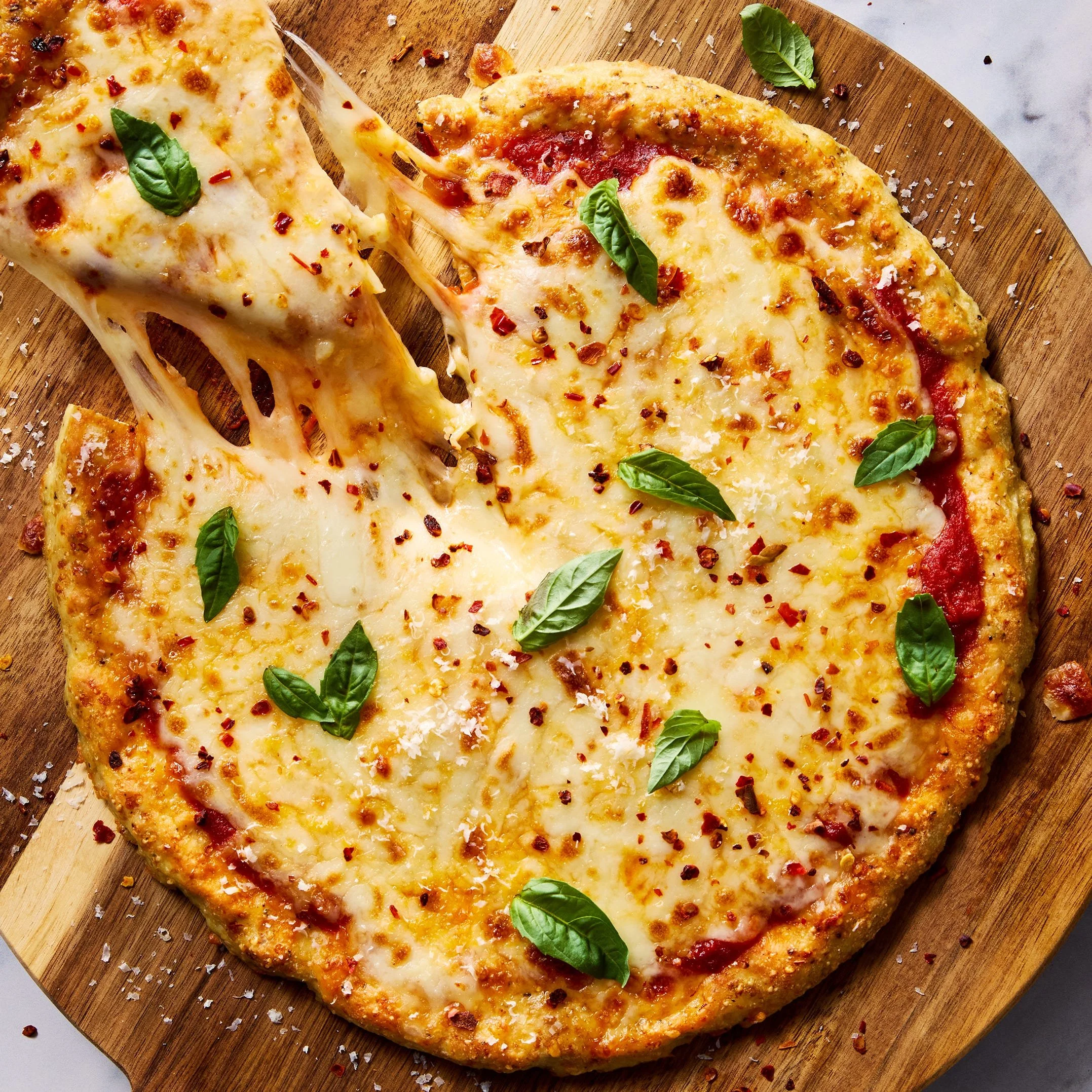 Protein-packed chicken parm pizza topped with cheese and marinara sauce